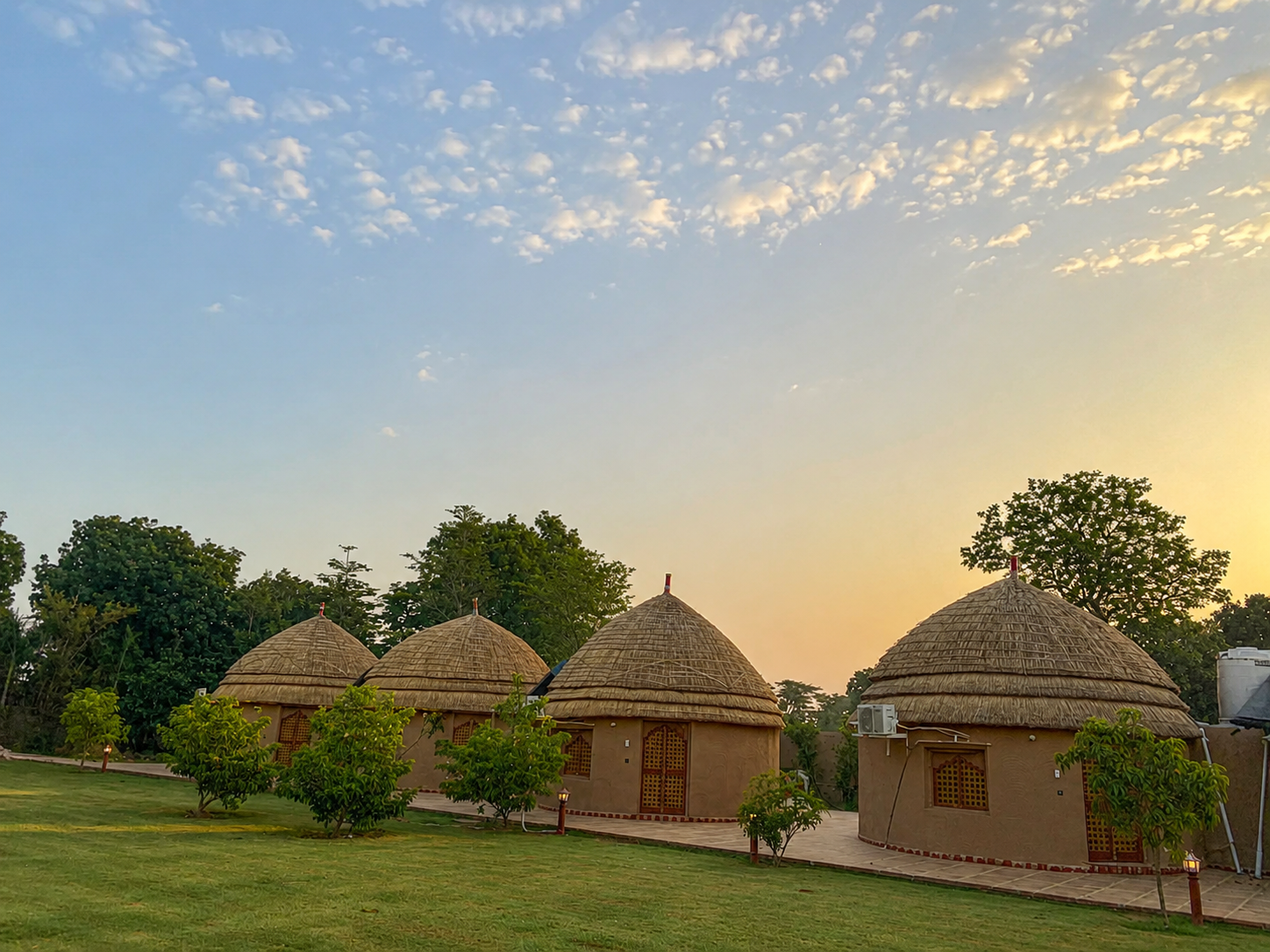 Marwadi huts exterior in daylight at Urban Dhani Resort